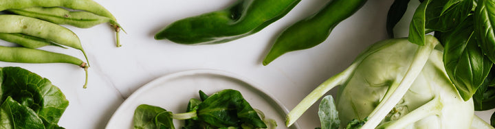 Green veggies on a white surface