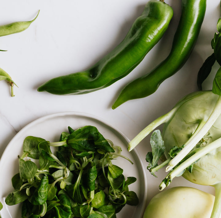Green veggies on a white surface