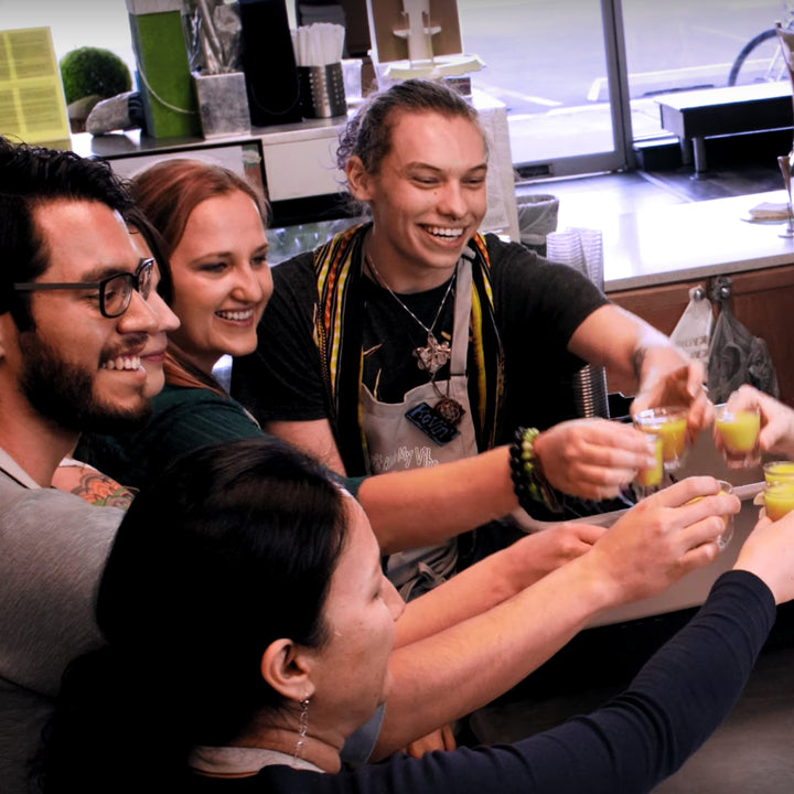 Pure Juice Cafe employees cheers juice shots