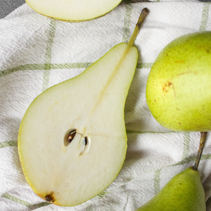 Pears on a green and white dish cloth
